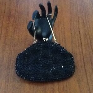 Elegant black satin bag covered in sequins and beads